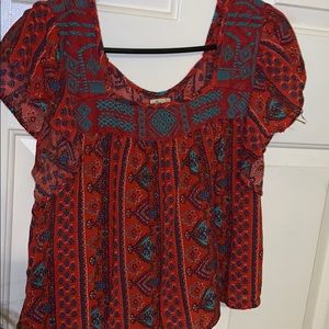 Red, flowy shirt with fun pattern
